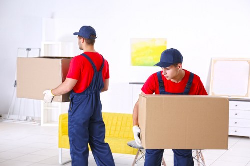 Man with a van helping load items onto a moving truck in the UK