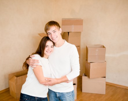Movers assisting with unloading a van at a new home